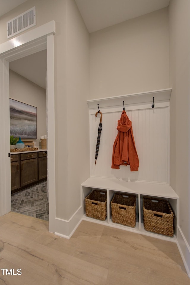 mudroom with baseboards and wood finished floors