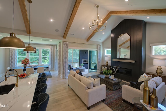 living area featuring light wood-type flooring, a chandelier, and recessed lighting