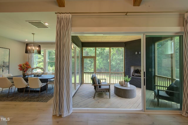 sunroom featuring a chandelier