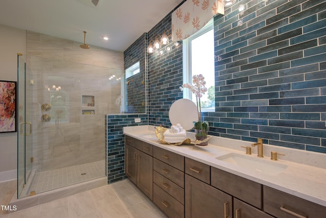full bath featuring a shower stall, tile walls, double vanity, and recessed lighting