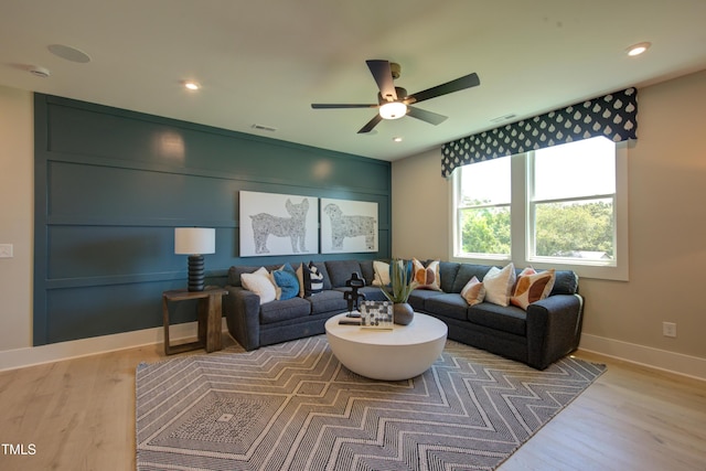 living area with a ceiling fan, wood finished floors, baseboards, and recessed lighting