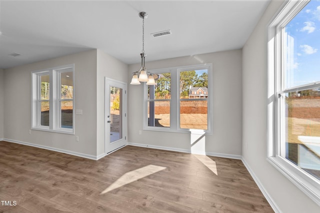 35 Windflower Ct Unit 9, Clayton, NC 27520 - unfurnished dining area with wood finished floors and a chandelier