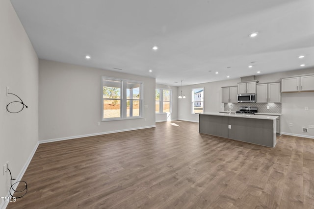 35 Windflower Ct Unit 9, Clayton, NC 27520 - unfurnished living room with recessed lighting and wood finished floors