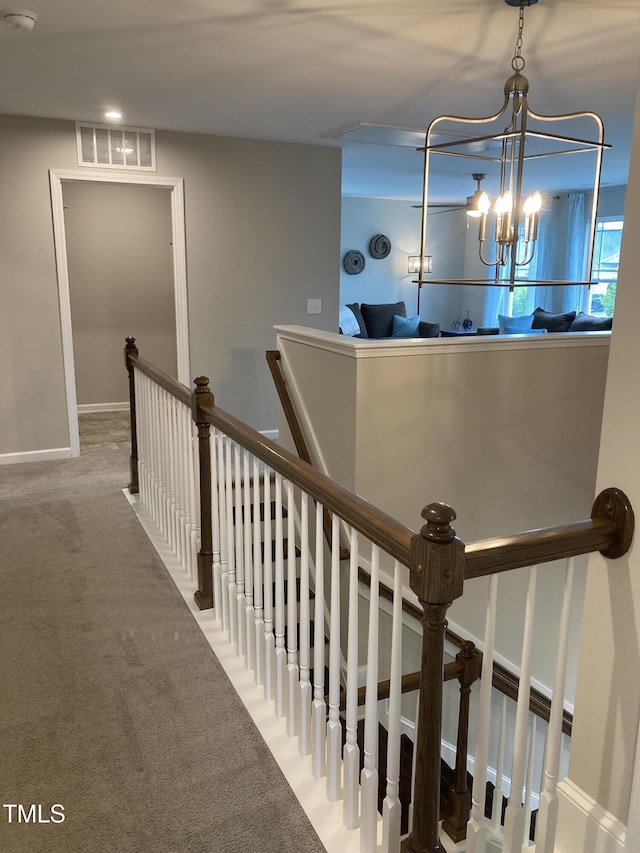 35 Windflower Ct Unit 9, Clayton, NC 27520 - stairway with a chandelier and carpet floors