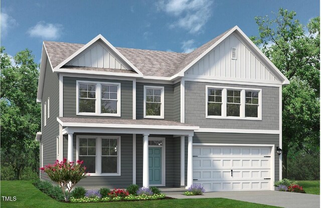 35 Windflower Ct Unit 9, Clayton, NC 27520 - view of front of home featuring board and batten siding, driveway, a shingled roof, and a garage