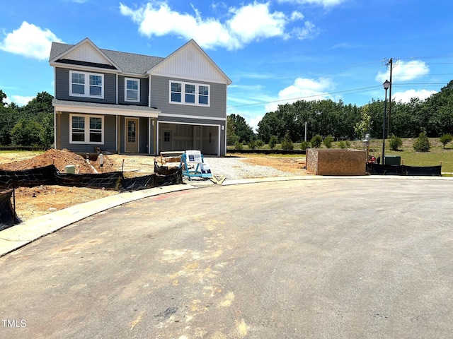 35 Windflower Ct Unit 9, Clayton, NC 27520 - view of front of home featuring driveway, a garage, and covered porch