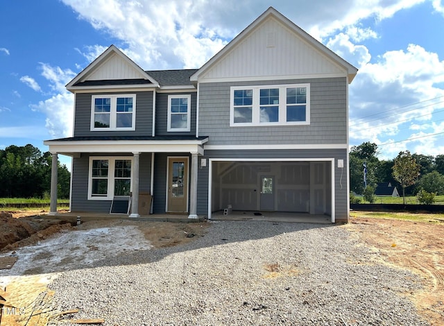 35 Windflower Ct Unit 9, Clayton, NC 27520 - view of front of home with gravel driveway, covered porch, and an attached garage