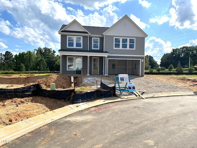 35 Windflower Ct Unit 9, Clayton, NC 27520 - view of front facade featuring driveway, a porch, and an attached garage