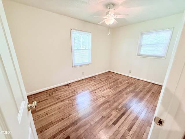 174 Carolina Dr, Reidsville, NC 27320 - unfurnished bedroom with wood finished floors, baseboards, and ceiling fan