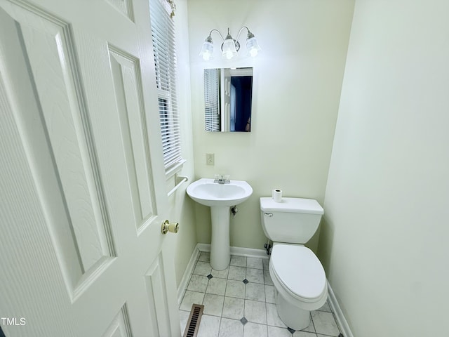 174 Carolina Dr, Reidsville, NC 27320 - bathroom with toilet, baseboards, tile patterned floors, and a sink