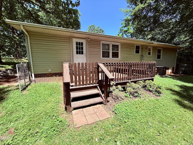 174 Carolina Dr, Reidsville, NC 27320 - rear view of house with cooling unit, a wooden deck, and a lawn