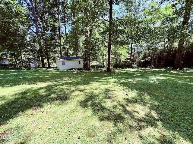 174 Carolina Dr, Reidsville, NC 27320 - view of green lawn featuring an outbuilding and a storage unit