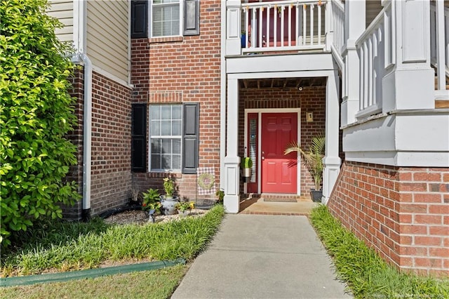 view of exterior entry with brick siding