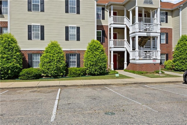 view of property featuring uncovered parking and central AC