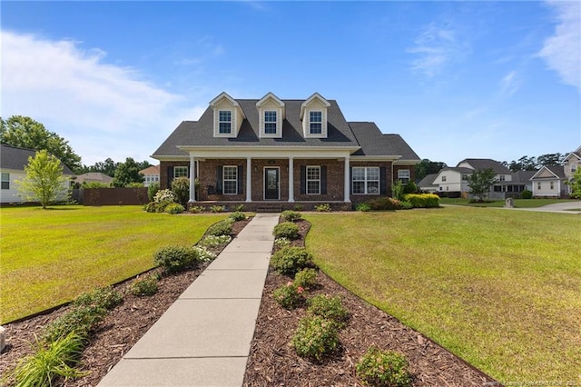 cape cod home with covered porch and brick siding