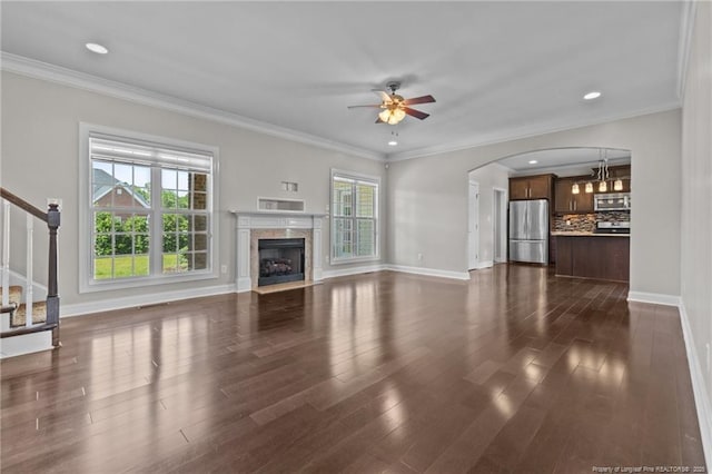 unfurnished living room featuring plenty of natural light, ceiling fan, baseboards, dark wood finished floors, and recessed lighting