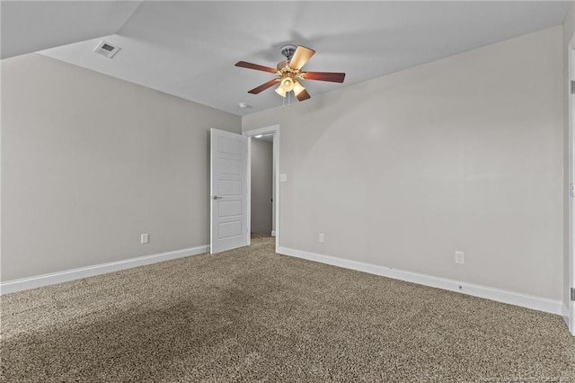 carpeted spare room with ceiling fan and baseboards
