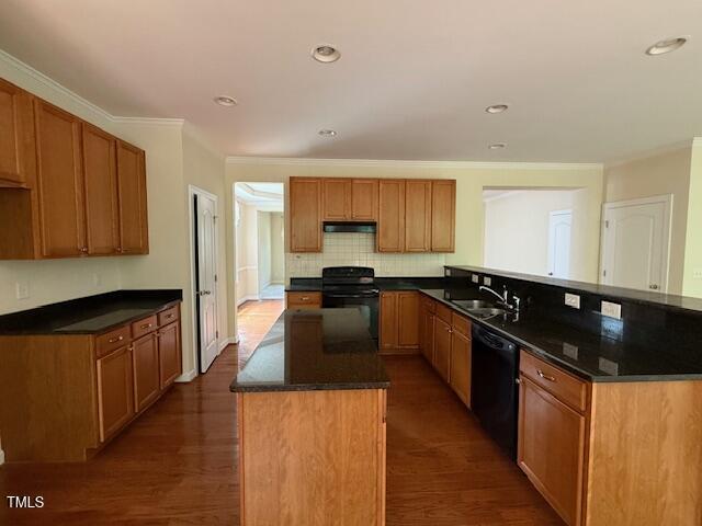 5804 Claribel Ct, Raleigh, NC 27612 - kitchen featuring black appliances, a sink, a kitchen island, a peninsula, and dark wood finished floors
