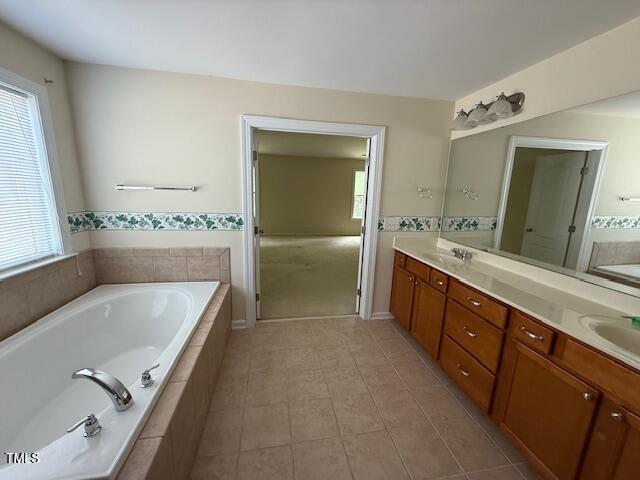 5804 Claribel Ct, Raleigh, NC 27612 - full bathroom featuring double vanity, a bath, and tile patterned flooring
