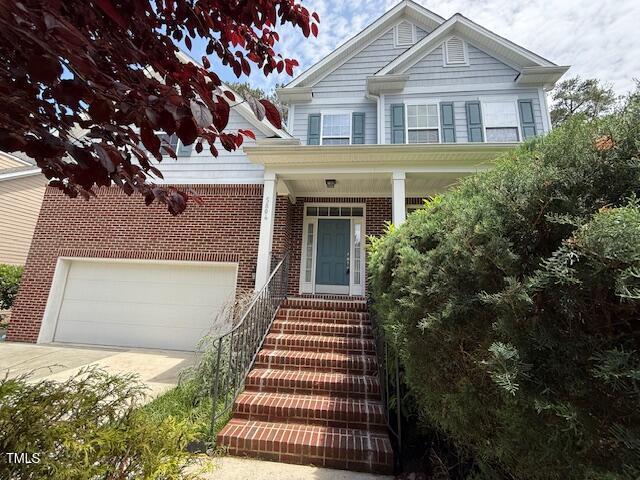 5804 Claribel Ct, Raleigh, NC 27612 - view of front of property featuring brick siding, driveway, and a garage
