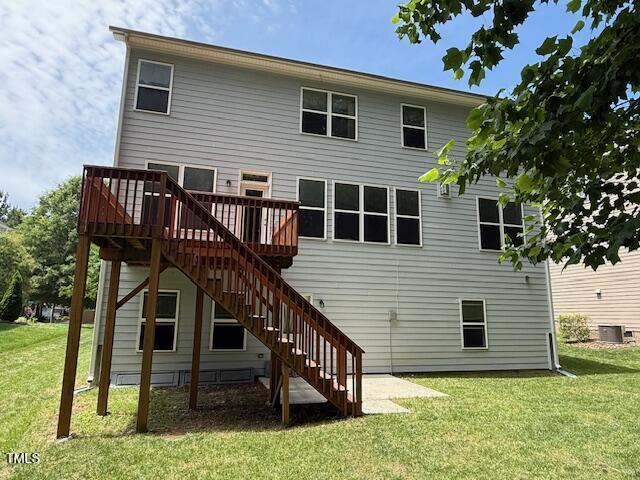 5804 Claribel Ct, Raleigh, NC 27612 - back of property featuring stairs, a wooden deck, a lawn, and central air condition unit