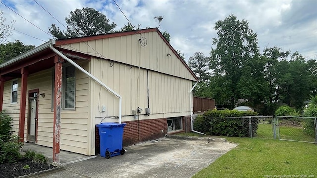 4313 Wellington Dr, Fayetteville, NC 28314 - view of side of home with board and batten siding and a patio