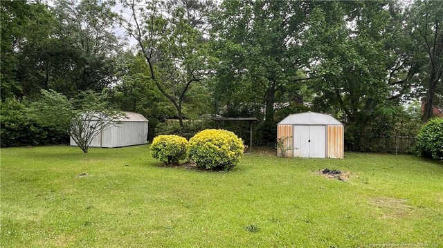 4313 Wellington Dr, Fayetteville, NC 28314 - view of yard with a storage unit, an outbuilding, and view of scattered trees