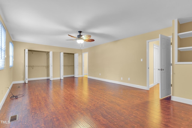 6423 New Market Way, Raleigh, NC 27615 - unfurnished bedroom featuring two closets, wood finished floors, and baseboards