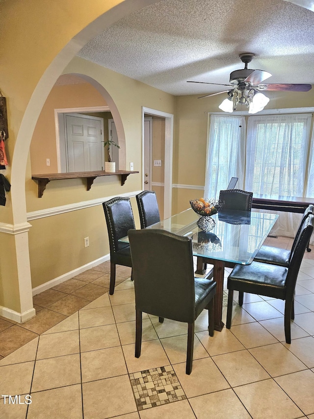 1360 Honeycutt Rd, Willow Springs, NC 27592 - dining area with a ceiling fan, light tile patterned floors, a textured ceiling, arched walkways, and baseboards
