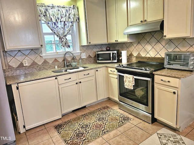 1360 Honeycutt Rd, Willow Springs, NC 27592 - kitchen with stainless steel appliances, a sink, under cabinet range hood, and light tile patterned floors
