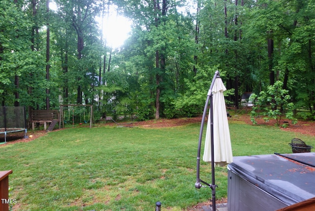 5917 Clearsprings Dr, Wake Forest, NC 27587 - view of yard featuring a trampoline, a hot tub, and a playground