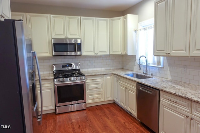 5917 Clearsprings Dr, Wake Forest, NC 27587 - kitchen featuring appliances with stainless steel finishes, a sink, decorative backsplash, and dark wood-type flooring