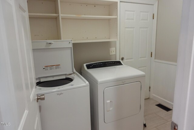 5917 Clearsprings Dr, Wake Forest, NC 27587 - washroom with washer and clothes dryer and a wainscoted wall