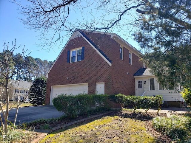 1711 Westbrook Dr NW, Wilson, NC 27896 - view of home's exterior with brick siding, a garage, and concrete driveway