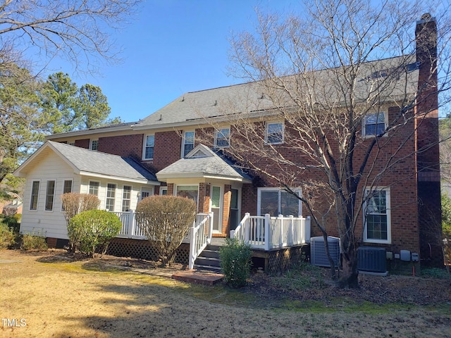 1711 Westbrook Dr NW, Wilson, NC 27896 - view of front of home featuring central air condition unit, a deck, and a chimney