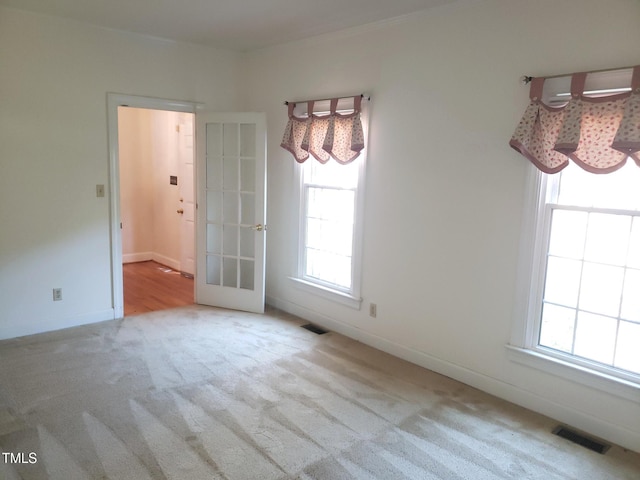 1711 Westbrook Dr NW, Wilson, NC 27896 - unfurnished dining area featuring carpet, healthy amount of natural light, baseboards, and french doors