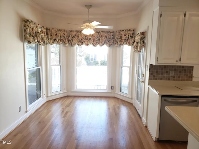 1711 Westbrook Dr NW, Wilson, NC 27896 - unfurnished dining area with light wood-style flooring, a ceiling fan, crown molding, and baseboards