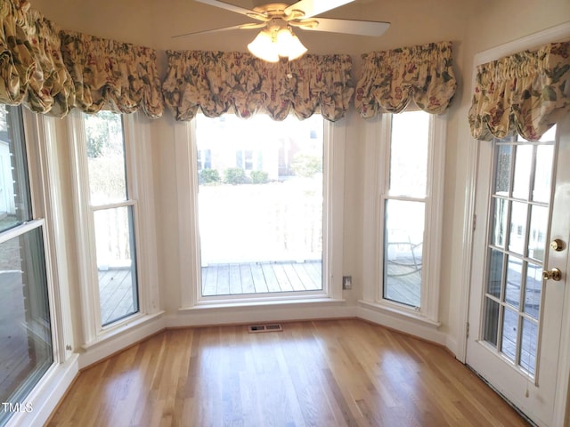 1711 Westbrook Dr NW, Wilson, NC 27896 - unfurnished dining area featuring light wood-style floors, healthy amount of natural light, baseboards, and a ceiling fan