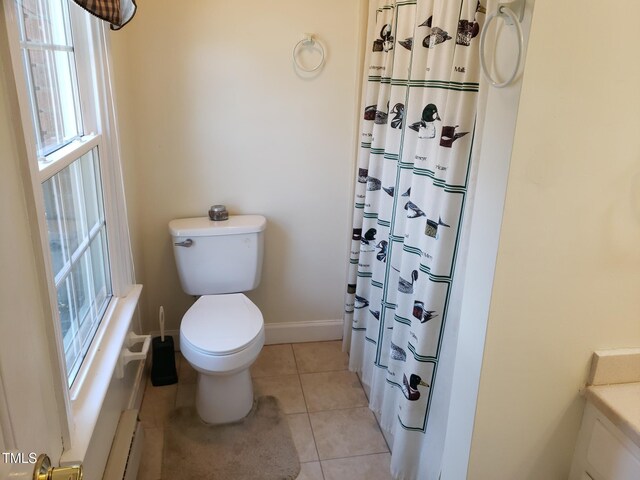 1711 Westbrook Dr NW, Wilson, NC 27896 - bathroom with a baseboard radiator, toilet, plenty of natural light, and tile patterned flooring