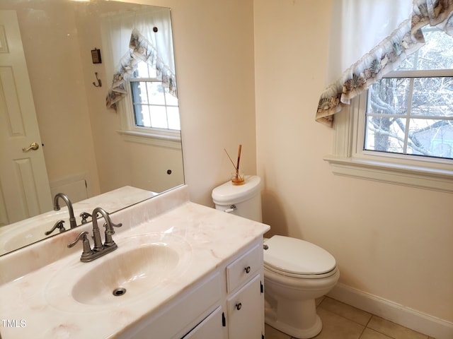 1711 Westbrook Dr NW, Wilson, NC 27896 - half bathroom featuring tile patterned floors, toilet, vanity, and baseboards