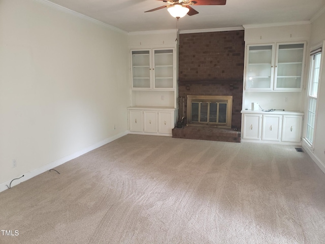 1711 Westbrook Dr NW, Wilson, NC 27896 - unfurnished living room featuring a ceiling fan, light colored carpet, a brick fireplace, ornamental molding, and baseboards