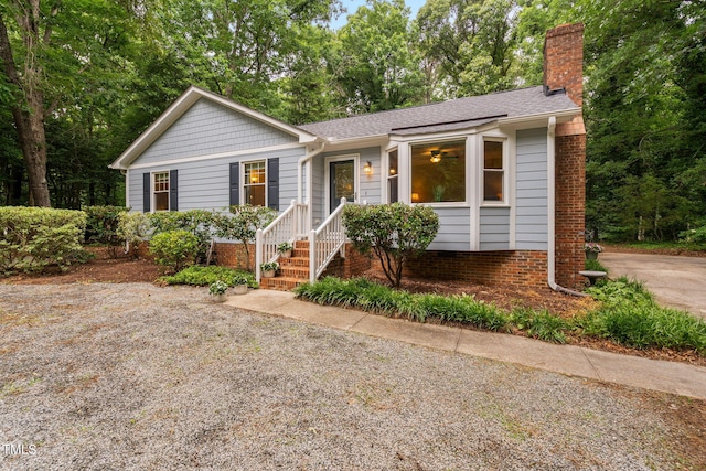 4004 Bamburgh Ln, Apex, NC 27539 - ranch-style home with a chimney, a shingled roof, and view of scattered trees