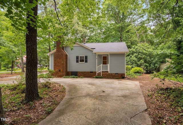 4004 Bamburgh Ln, Apex, NC 27539 - view of front of house featuring crawl space, roof with shingles, a chimney, and driveway