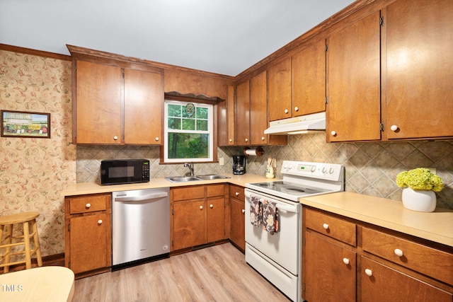 4004 Bamburgh Ln, Apex, NC 27539 - kitchen with dishwasher, white range with electric stovetop, black microwave, under cabinet range hood, and a sink