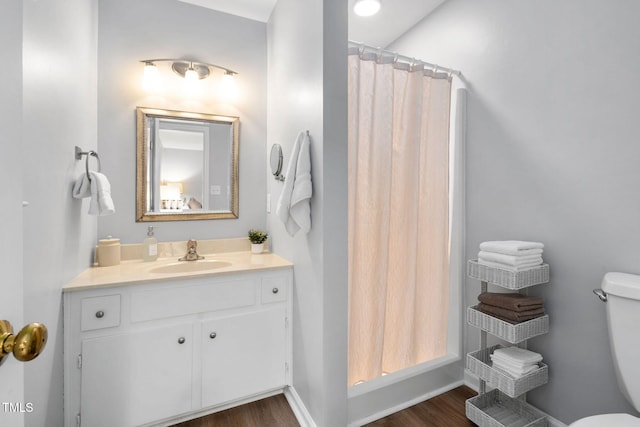 4004 Bamburgh Ln, Apex, NC 27539 - full bathroom with toilet, vanity, wood finished floors, and baseboards