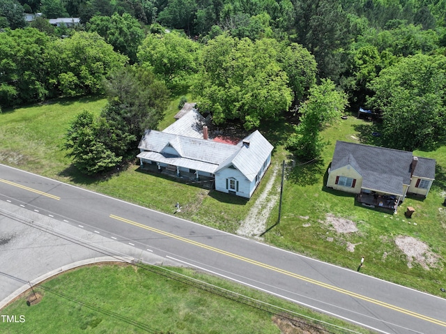 aerial view of property and surrounding area with a forest