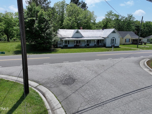 view of asphalt road with view of scattered trees