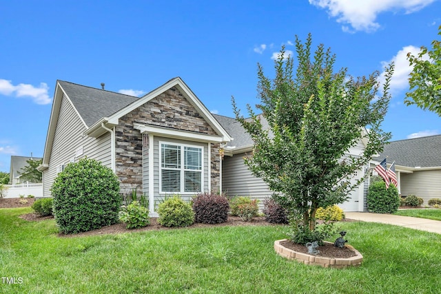 2033 Buck Corner Ln, Fuquay Varina, NC 27526 - view of front of house with stone siding, an attached garage, a front yard, and concrete driveway