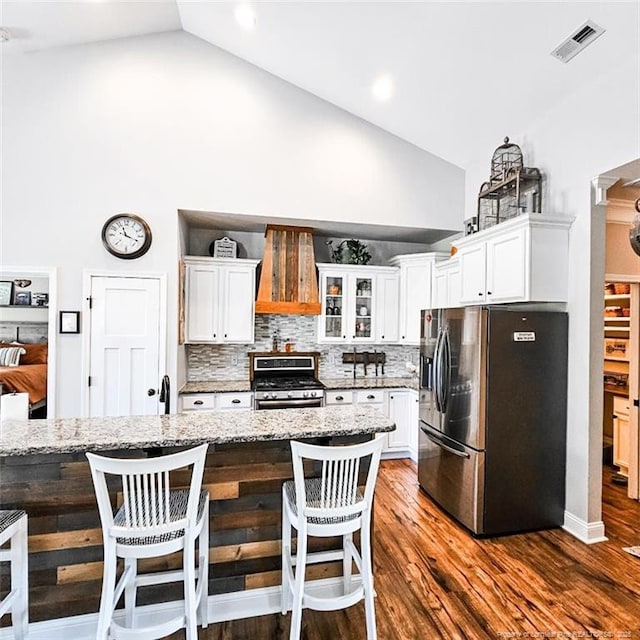 1303 Palestine Rd, Linden, NC 28356 - kitchen featuring appliances with stainless steel finishes, high vaulted ceiling, premium range hood, white cabinets, and backsplash