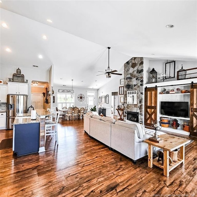1303 Palestine Rd, Linden, NC 28356 - living room with ceiling fan, dark wood-style flooring, lofted ceiling, a fireplace, and recessed lighting